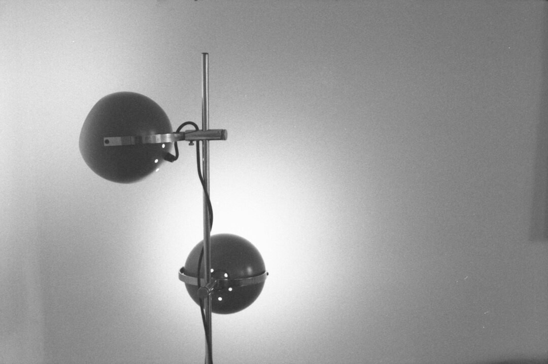 Technicians setting up lighting rigs on a television studio floor