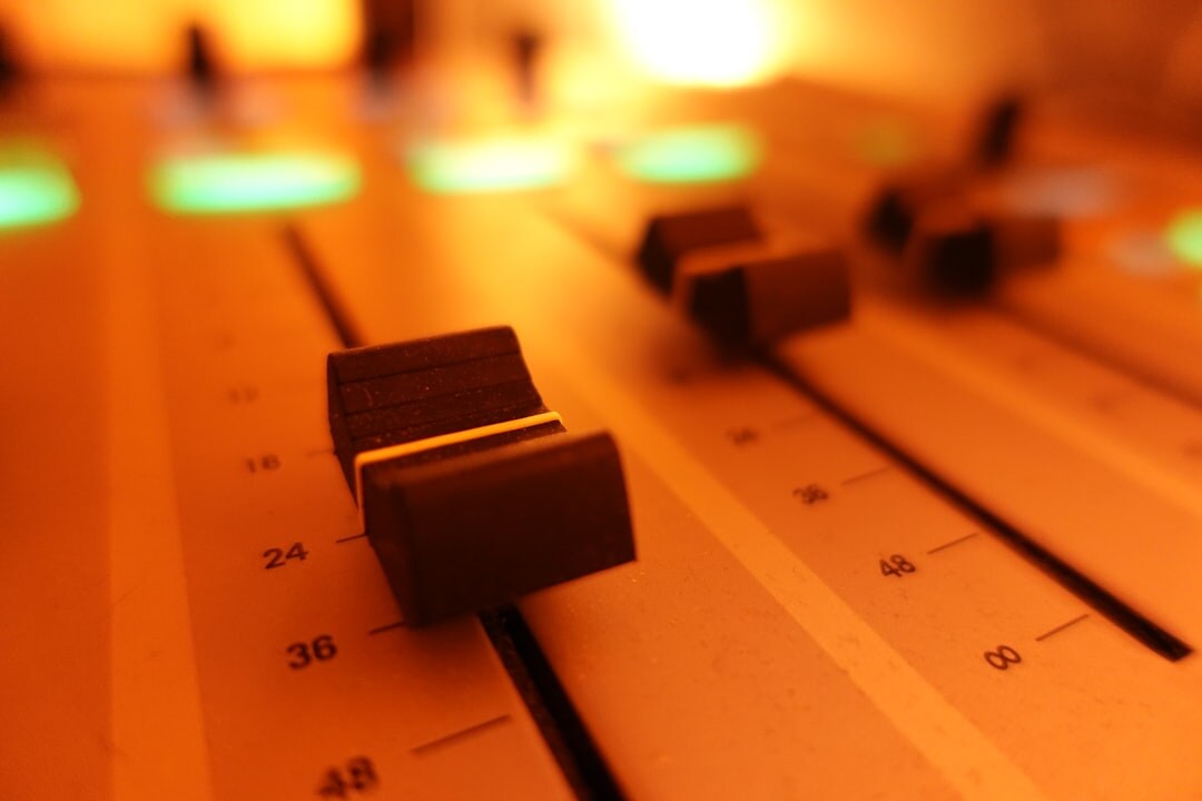 Sound engineer monitoring audio waveforms at a mixing console